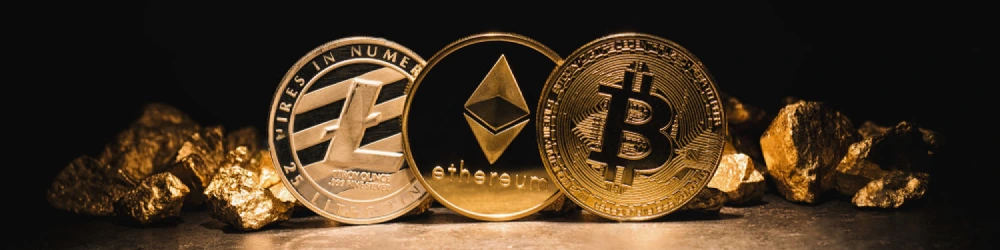 Litecoin, Ethereum, and Bitcoin coins in front of gold nuggets.