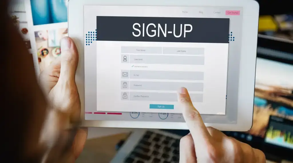 Tablet displaying a sign-up form, with a user entering their details to create an account.