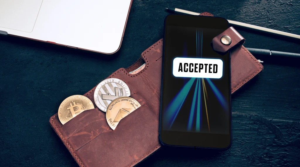 A leather wallet displaying a symbol indicating acceptance of Bitcoin as a payment method.