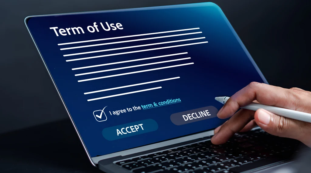 Laptop screen displaying a 'Terms of Use' agreement with options to accept or decline, emphasizing the importance of reviewing terms carefully.