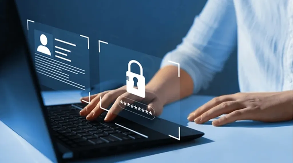 A person typing on a laptop with digital security icons, including a padlock and user profile.