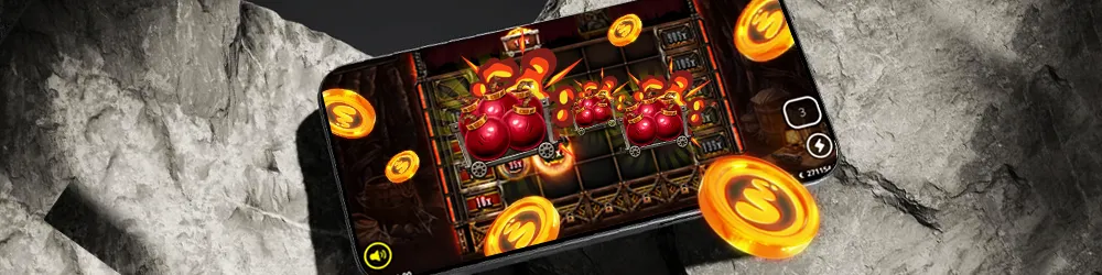 A smartphone screen showing a slot game with explosive red barrels and coins spinning on the reels, surrounded by floating golden coins and dramatic lighting.