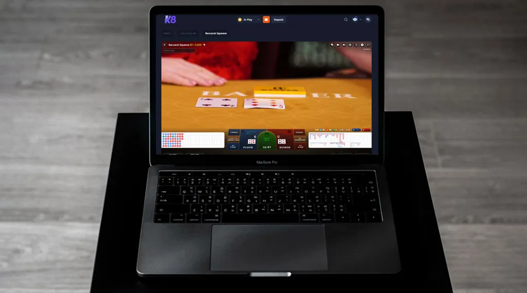 A laptop featuring a poker game interface on the screen, showcasing cards and chips in play.