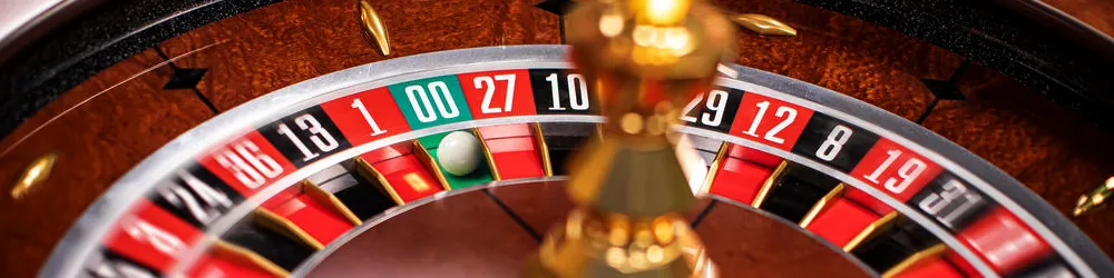 Close-up image of a roulette wheel in a casino, featuring the ball resting in one of the numbered slots.