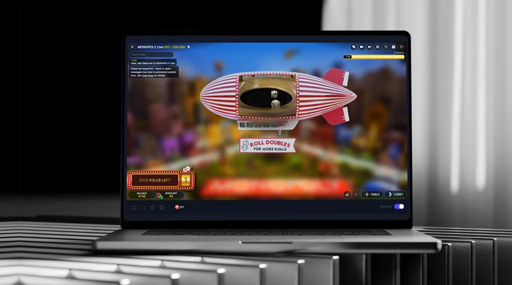 A laptop displaying an active video game on its screen, with colorful graphics and game controls visible.