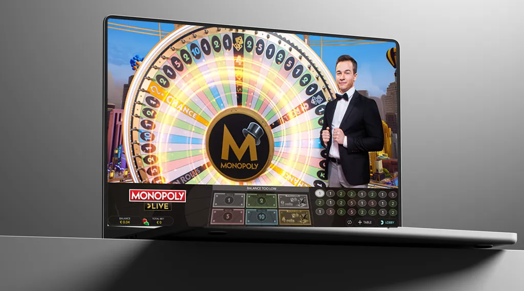 A laptop displaying a colorful Monopoly Live game on its screen.